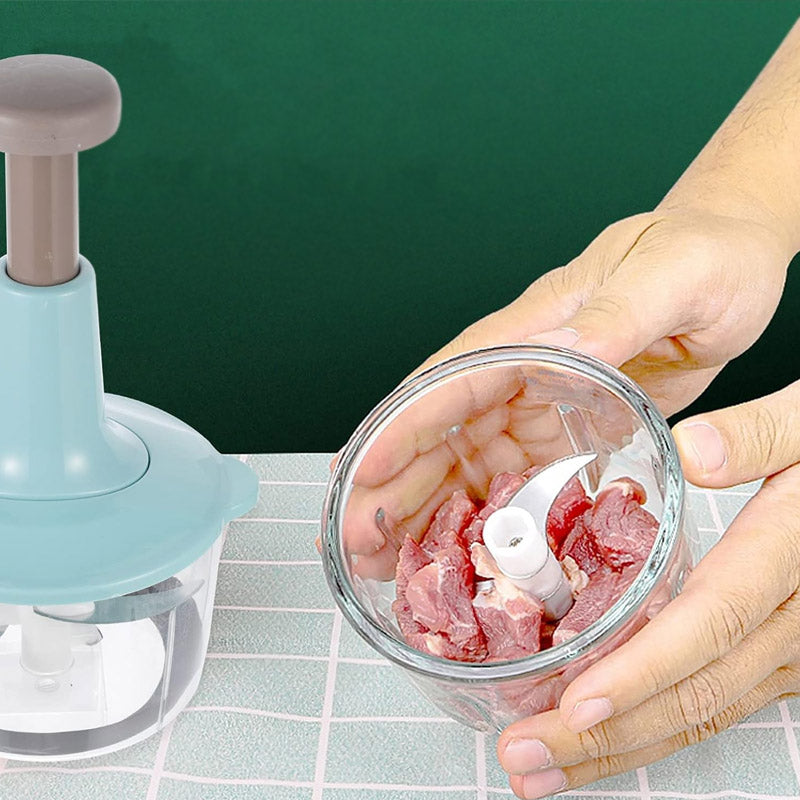 Hands holding a glass bowl with raw meat inside an AVIOX manual press food chopper.