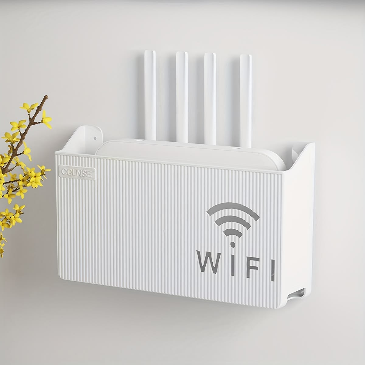 White AVIOX router storage box mounted on a wall to organize wires and hide a router.